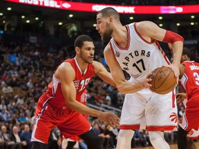 Raptors centre Jonas Valanciunas shields the ball from Clippers’ Jeff Ayres during  the fourth quarter at the Air Canada Centre on Sunday night. (USA TODAY SPORTS/PHOTO)