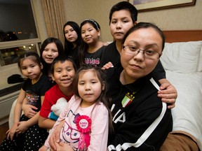 Joy Cardinal and her seven kids have been living in two north Edmonton hotel rooms after a Jan. 22, 2016 fire destroyed their home, in Edmonton Alta. on Sunday Jan. 24, 2016. (Left to right back row) Sierra Cardinal, 15, Nadya Bigstone, 9, Nikolai Bigstone, 10, (Front row left to right) Shanti Cardinal, 13, Niqua Bigstone, 6, Sonny Bigstone, 8, Summer Bigstone, 5, and Joy Cardinal.