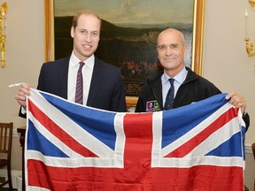 Prince William (L) holds a Union flag as he poses with explorer Henry Worsley at Kensington Palace in London, in this file photograph dated October 19, 2015. REUTERS/John Stillwell/files