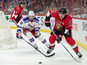 Ottawa Senators defenseman Mark Borowiecki skates with the puck in front of New York Rangers center Derick Brassard in the first period at the Canadian Tire Centre. (Marc DesRosiers/USA TODAY Sports)