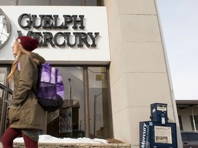 A woman walks by the Guelph Mercury office in Guelph, Ont. on Monday, Jan. 25, 2016. THE CANADIAN PRESS/Hannah Yoon