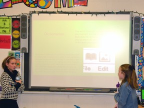 As part of St. Columban School's Tech Night, students from all grades demonstrated for their parents the suite of software they have started using on a daily basis to help them learn both in and outside of the classroom. Grades 5/6 students Arianna Catalan (left), Rebecca McCarthy and Joe Ertel demonstrated a program called Mindomo, which is like a virtual bulletin board that students can pin videos, pictures and websites to, and can also be used for class presentations. GALEN SIMMONS/MITCHELL ADVOCATE