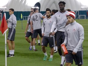 Italian striker Sebastian Giovinco (right) and teammates attend training camp, Monday, Jan.25, 2016 under the bubble at Toronto FC’s training facility. THE CANADIAN PRESS/Neil Davidson