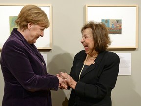 German Chancellor Angela Merkel stands with Holocaust survivor, artist Nelly Toll (R) at the exhibition "Art from the Holocaust" at the Deutsches Historisches Museum (German Historical Museum) in Berlin, Germany, January 25, 2016. The museum presents 100 art works from the Yad Vashem Collection in Jerusalem.    REUTERS/Britta Pedersen/Pool