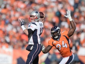 New England Patriots quarterback Tom Brady (12) passes as Denver Broncos linebacker DeMarcus Ware (94) closes in during the AFC Championship game at Sports Authority Field at Mile High. (Ron Chenoy/USA TODAY Sports)