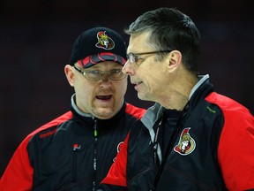 Senators head coach Dave Cameron and assistant Andre Tourigny talk things over at practice on Jan. 25. (Darren Brown, Postmedia Network)