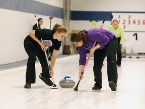Samantha Gibson and Katie Cummings of Lo Ellen Park Secondary school sweep on a shot from skip Brooklyn Clark during girls high school curling in Sudbury, Ont. on Monday January 25, 2016.
