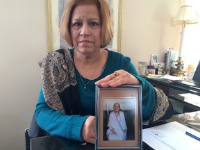 Afshan Khan poses with a photo of her mother, Aziz Un Nisa, 80. Khan is upset about the care Aziz has received at the Queensway-Carleton Hospital. (Blair Crawford/Ottawa Citizen
