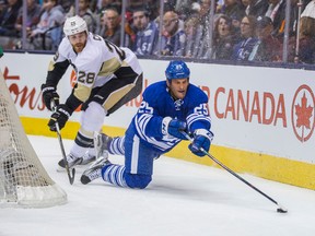 Toronto Maple Leafs forward Rich Clune is tripped up by Pittsburgh Penguins defender Ian Cole during NHL play at the Air Canada Centre in Toronto on Saturday October 31, 2015. (Ernest Doroszuk/Toronto Sun/Postmedia Network)