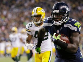 In this Sept. 4, 2014, file photo, Seattle Seahawks fullback Derrick Coleman, right, runs for a touchdown against the Green Bay Packers in Seattle. (AP Photo/Elaine Thompson, File)