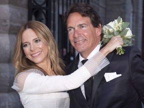 Parti Quebecois leader Pierre Karl Peladeau and Julie Snyder hug after getting married in Quebec City, on Aug. 15, 2015. (THE CANADIAN PRESS/Jacques Boissinot)