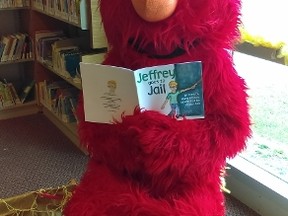 Elmo reads a passage from CFCN's United Nations recognized storybook Jeffrey Goes to Jail. The CFCN is hosting a family fun event at Sarnia Public Library on Saturday, Jan. 30 to raise awareness and share resources about families affected by incarceration and crime. 
Submitted photo for SARNIA THIS WEEK