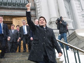 Prime Minister Justin Trudeau gives a 'thumbs up' to protesters following his meeting with Montreal Mayor Denis Coderre in Montreal, on Jan. 26, 2016. (THE CANADIAN PRESS/Graham Hughes)