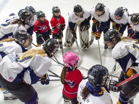 The Lucknow Legends teach three younger “future Legends” the team’s pregame cheer before taking on the Clifford Barn Cats in an exhibition game Saturday, Jan. 23, during the 5th annual Women’s Hockey Day in Lucknow. (Darryl Coote/Reporter)