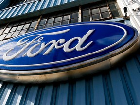 This Thursday, Nov. 19, 2015, photo, shows a blue oval Ford sign above the entrance to Butler County Ford in Butler, Pa. (AP Photo/Keith Srakocic)