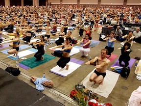 In this Sept. 27, 2003, file photo, Bikram Choudhury, front, founder of the Yoga College of India and creator and producer of Yoga Expo 2003, leads what organizers hope will be the world's largest yoga class at the Expo at the Los Angeles Convention Center. (AP Photo/Reed Saxon, File)