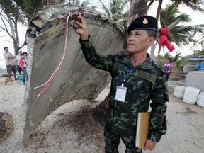A Thai army soldier inspects a piece of suspected plane wreckage which has been found off the coast of southern Thailand in Nakhon Si Thammarat province, in this Jan. 24, 2016 file photo. The piece of suspected plane wreckage found off the coast of southern Thailand on Saturday does not belong to Malaysia Airlines Flight MH370 that disappeared almost two years ago, the Malaysian transport ministry said on Tuesday. (REUTERS/Surapan Boonthanom/Files)