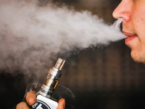 A man smokes an electronic cigarette vaporizer. (REUTERS/Mark Blinch/Files)