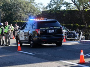 Police block an entrance near the Naval Medical Center San Diego, Tuesday, Jan. 26, 2016, in San Diego. The Navy said authorities responded to a report of gunshots at a building on the campus. (AP Photo/Lenny Ignelzi)