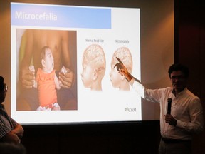Colombia's Health Minister Alejandro Gaviria, right, explains possible health complications associated with the Zika virus during an event to launch a nationwide prevention campaign in Ibague, Colombia, Tuesday, Jan. 26, 2016. Gaviria said the mosquito-borne Zika virus has already infected more than 16,000 people in Colzombia and could hit more than half a million throughout the country. (AP Photo/Fernando Vergara)