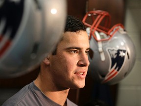 U.S. Navy Ensign Joe Cardona, a long snapper with the New England Patriots, speaks with reporters in the locker room at Gillette Stadium in Foxborough, Mass., on Nov. 11, 2015. (AP Photo/Steven Senne)