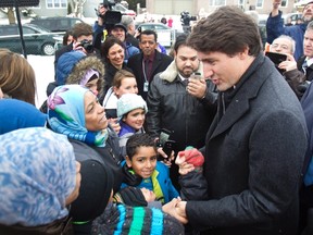 Prime Minister Justin Trudeau greets refugee families who recently arrived in Canada at an open house of the Masjid Al-Salaam Mosque in Peterborough Ont., Sunday, January 17, 2016. (THE CANADIAN PRESS/Fred Thornhill)