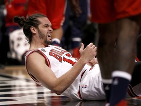 Chicago Bulls centre Joakim Noah gets off the floor after falling on his left shoulder during an NBA game against the Washington Wizards, Monday, Jan. 11, 2016, in Chicago. (AP Photo/Charles Rex Arbogast)