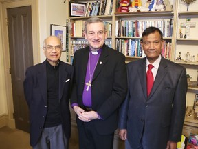 Anglican Bishop Michael Oulton, centre, stands with Sam Laldin, right, and Dr. Soni Pancham of the Christian Cultural Association of South Asians on Tuesday. The church and the association are working together on an educational bursary fund for youths affected by terrorist violence in Pakistan. (Elliot Ferguson/The Whig-Standard)