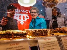 Premier Kathleen Wynne along with Finance Minister Charles Sousa and Associate Finance Minister Mitzie Hunter visit the Impact Kitchen on King St. E. in Toronto to talk about the Ontario Registered Pension Plan on Tuesday, January 26, 2016. (Dave Thomas/Toronto Sun)