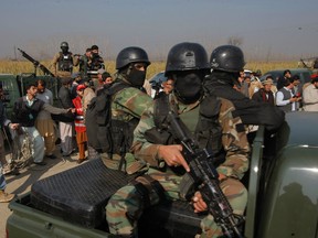 Pakistani troops arrive at the Bacha Khan University in Charsadda town, some 35 kilometers (21 miles) outside the city of Peshawar, Pakistan, Wednesday, Jan. 20, 2016. Gunmen stormed Bacha Khan University named after the founder of an anti-Taliban political party in the country's northwest Wednesday, killing many people, officials said. (AP Photo/Mohammad Sajjad)