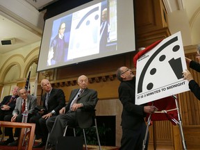 The Bulletin of the Atomic Scientists member Lynn Eden, right, and editor-in-chief John Mecklin, second from right, unveil the "Doomsday Clock," which measures the likelihood of a global cataclysm, at Stanford University in Stanford, Calif., Tuesday, Jan. 26, 2016. Also pictured are former U.S. Secretary of State George Shultz, from left, former U.S. Secretary of Defense William Perry, Gov. Jerry Brown, and Jerry Seelig. The bulletin announced that the minute hand on the metaphorical clock remained at three minutes-to-midnight. The clock reflects how vulnerable the world is to catastrophe from nuclear weapons, climate change and new technologies, with midnight symbolizing apocalypse.  (AP Photo/Jeff Chiu)