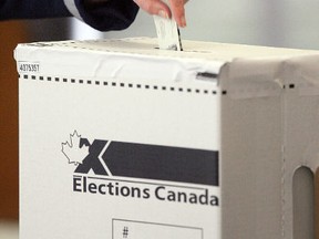A voter casts a ballot. (David Bloom/Postmedia).