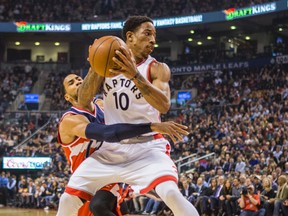 Raptors’ DeMar DeRozan is guarded by the Wizards’ Garrett Temple at the Air Canada Centre on Tuesday night. (Ernest Doroszuk/Toronto Sun)