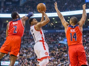 Toronto Raptors guard Kyle Lowry shoots between Washington Wizards defenders John Wall and Gary Neal at the Air Canada Centre in Toronto Tuesday January 26, 2016. (Ernest Doroszuk/Toronto Sun/Postmedia Network)