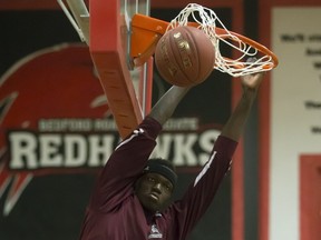 Adong Makuoi of the Archbishop O’Leary Spartans dunks the ball in warmups in the annual BRIT basketball classic in Saqskatoon earlier this month. (Greg Pender)