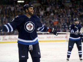 Winnipeg Jets' Dustin Byfuglien (33) laughs after scoring from just inside centre ice against the Arizona Coyotes during second period NHL hockey action, in Winnipeg, Tuesday, January 26, 2016. THE CANADIAN PRESS/Trevor Hagan