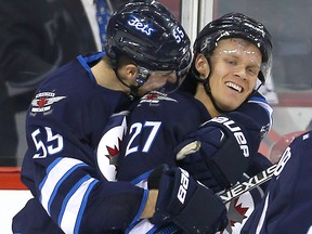 Winnipeg Jets right winger Nikolaj Ehlers (right) is hugged by centre Mark Scheifele following his third goal of the game against the Arizona Coyotes January 26, 2016.