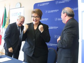 Gino Donato/Sudbury Star
Lyne Michaud, director of the school of business, hospitality and tourism/agri-food research and training at La Cite, gestures her excitement after signing an articulation agreement with Pierre Riopel, president of College Boreal, and Dominic Giroux, president of Laurentian University. The agreement accelerates the process of obtaining a bachelor of business administration at Laurentian for graduates of Ontario's two francophone colleges.