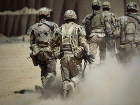 Canadian soldiers patrol southwest of Kandahar, Afghanistan, Monday, June 7, 2010. A new study says approximately half of military personnel in Canada begin their service with a history of abuse in their childhood, including corporal punishment, or witnessed domestic violence as children. THE CANADIAN PRESS/AP/Anja Niedringhaus