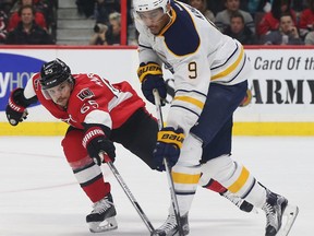 The Ottawa Senators took on the Buffalo Sabres at the Canadian Tire Centre in Ottawa Ontario Tuesday Jan 26, 2016. Senators Erik Karlsson tries to get the puck away from Sabres Evander Kane during second period action Tuesday.   Tony Caldwell/Postmedia Network