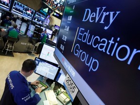 Specialist Neil Gallagher works at the post that handles DeVry Education Group, on the floor of the New York Stock Exchange, Wednesday, Jan. 27, 2016. The government is suing the operators of the for-profit DeVry University, alleging they misled consumers about students' jobs and earnings prospects. (AP Photo/Richard Drew)