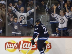 Winnipeg Jets' Dustin Byfuglien (33) dabs after scoring against the Arizona Coyotes' during third period NHL hockey action in Winnipeg, Tuesday, January 26, 2016. THE CANADIAN PRESS/Trevor Hagan