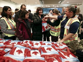 Syrian refugees receive welcome bags at Toronto Pearson International Airport in Mississauga on Dec. 11, 2015. (Reuters/Mark Blinch)