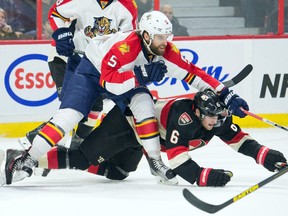 Ottawa Senators right wing Bobby Ryan (6) is checked by Florida Panthers defenseman Aaron Ekblad (5) in the second period at the Canadian Tire Centre.  Marc DesRosiers-USA TODAY Sports