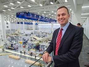 Fred Cromer, president of Bombardier's commercial aircraft division, poses for photos above the CS100 assembly line at the company's plant Friday, December 18, 2015 in Mirabel, Que. (THE CANADIAN PRESS/Ryan Remiorz)