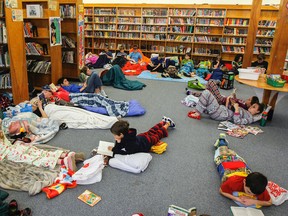 The RG Sinclair Public School library is filled with more than 100 students in their pyjamas, wrapped in blankets while reading. Students in grades 4 to 8 are taking part in the ninth annual read-a-thon. (Julia McKay/The Whig-Standard)
