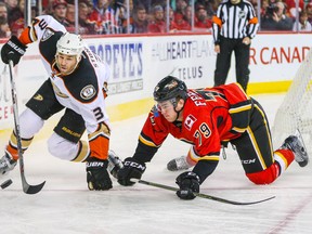 Anaheim Ducks defenceman Clayton Stoner (3) and Calgary Flames winger Micheal Ferland battle for the puck at Scotiabank Saddledome. (Sergei Belski/USA TODAY Sports)