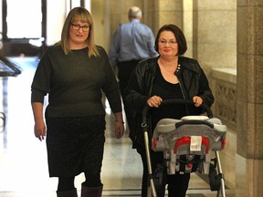 MLA Jennifer Howard (right) and wife Tara Seel wheel their 18-month-old Georgia Peel to a media opportunity at the Manitoba Legislature on Wed., Jan. 27, 2016 where Howard announced she won't run in the upcoming provincial election.