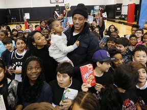 DeMar DeRozan and fiancee Kiara Morrison hold two-year-old daughter Diar at First Book Canada press conference on literacy at the Air Canada Centre in Toronto on Wednesday January 27, 2016. (Michael Peake/Toronto Sun)