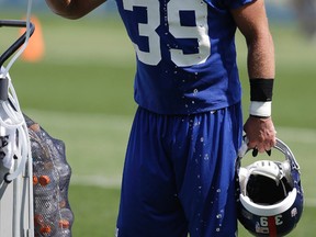 In this Saturday, July 27, 2013, file photo, New York Giants safety Tyler Sash cools off at a water fountain during NFL football training camp in East Rutherford, N.J. (AP Photo/Julio Cortez, File)